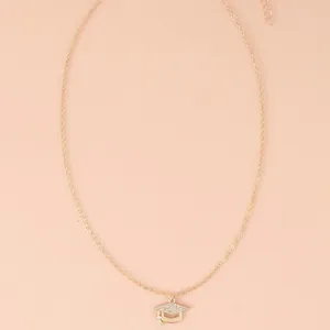 Detail of a golden mortarboard necklace with sparkling rhinestones for graduation