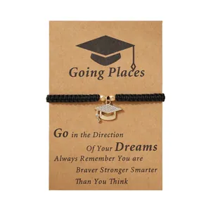 Braided black cord bracelet with a rhinestone graduation cap pendant on a gift card