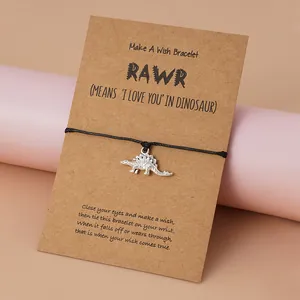 Bracelet de vœux dinosaure fait main sur carte kraft avec cordon tressé noir