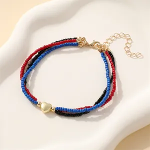 Three-layer colorful beaded heart bracelet with gold accents and adjustable chain