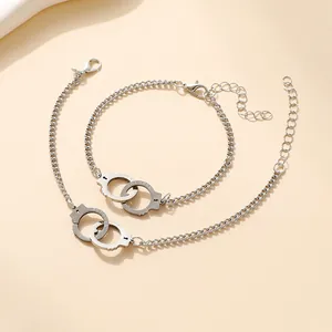 Silver interlocking handcuff bracelets with 'PUT DOWN' engraving and adjustable chains