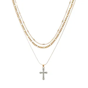 Triple-layered gold cross pendant necklace with figaro chain and crystal accents