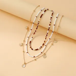 Three-layer bohemian beaded necklace set with golden fan-shaped shell pendants
