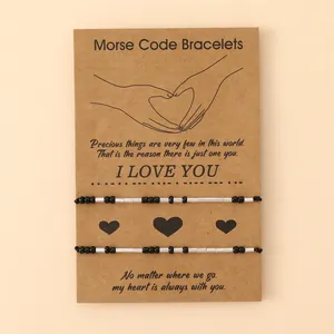 Morse code couple bracelet set with black beads and adjustable rope on I Love You card