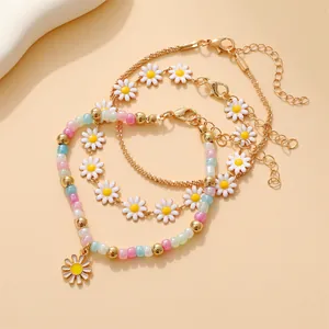 Ensemble de 3 bracelets dorés avec breloques tournesol, perles colorées et marguerites