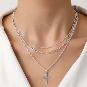 Silver multi-layer necklace with Figaro chains and crystal-studded cross pendant