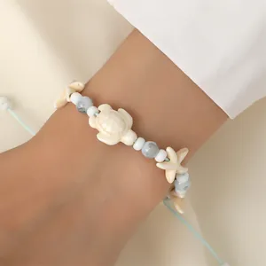 Bohemian kralenarmband met schildpad en zeester en lichtblauw verstelbaar koord