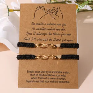 Set di 2 braccialetti dell'amicizia con simbolo infinito e cuore su cordino intrecciato nero