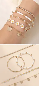 Close-up of bohemian multilayer bracelet set with sunflower charms and faux pearls