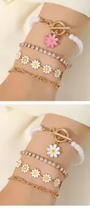 Detail of multi-layer sunflower pearl bracelets with gold OT buckle and daisy charms