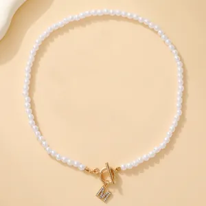 Elegant pearl necklace with crystal letter M pendant and gold OT toggle clasp closure