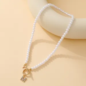 Elegant pearl necklace with gold OT buckle and iced-out diamond letter M pendant