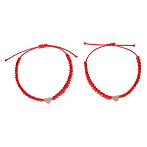 Set of two handmade red braided rope bracelets with polished gold heart-shaped charms