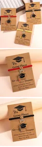 Detail of woven graduation bracelets with rhinestone-set mortarboard charms on gift cards
