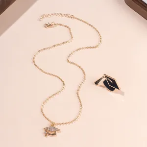 Golden graduation cap necklace with sparkling rhinestones on a matching display card