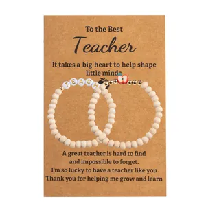 Teacher gift set featuring polymer clay apple charms and teach letter beads on card