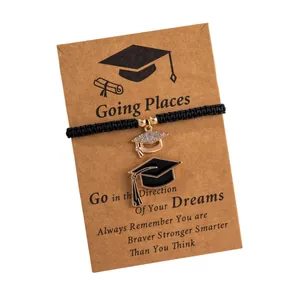 Adjustable graduation charm bracelet with sparkling mortarboard pendants on a gift card
