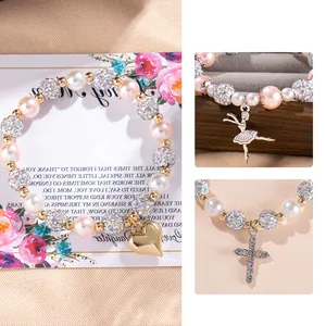 Pink pearl stretch bracelet featuring sparkling crystal balls and a golden heart pendant