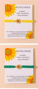 Detail of sunflower charm braided bracelets in yellow and green on display cards