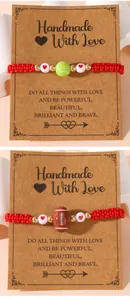 Detail of handmade red braided sports bracelets with tennis and football charms