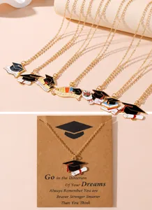 Detail view of graduation cap and diploma pendant necklace on vintage display card
