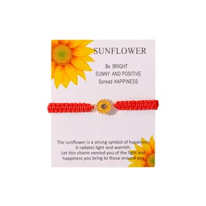 Handcrafted red woven sunflower bracelet displayed on a meaningful gift message card