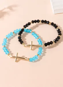 Detail shot of assorted colorful crystal bead bracelets with gold cross pendants