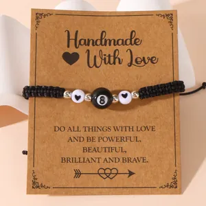 Handmade woven sports bracelet with black billiard ball and heart beads on card