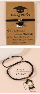 Detail of hand-woven graduation bracelet with enamel mortarboard charm and message card