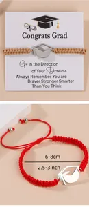 Detail view of woven graduation bracelets with doctoral cap charms and gift cards