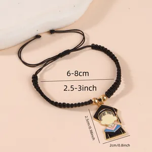 Adjustable black braided graduation bracelet featuring an enamel mortarboard charm