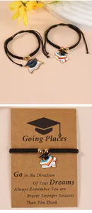 Detail of handmade woven graduation bracelets with doctor hat charms on gift cards