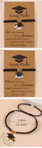 Macro detail of hand-woven graduation bracelets with enamel mortarboard charms on cards