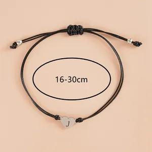 Adjustable black woven rope bracelet with stainless steel heart pendant engraved with letter J