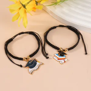 Adjustable woven graduation bracelets with doctoral hat and book enamel charms