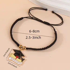 Adjustable black woven graduation bracelet with doctoral cap and diploma charm pendant