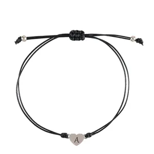 Adjustable black woven rope bracelet featuring a stainless steel heart charm with letter A