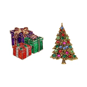 Christmas enamel brooches featuring gift boxes and a crystal-studded golden tree