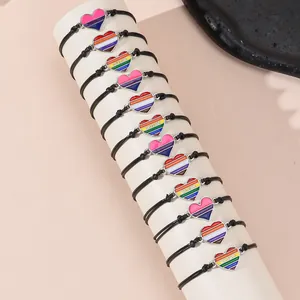 12-piece set of LGBTQ+ rainbow heart charm bracelets with adjustable woven cords