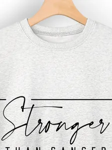 Detail of crew neck ribbing and Stronger Than Cancer print on heather grey sweatshirt