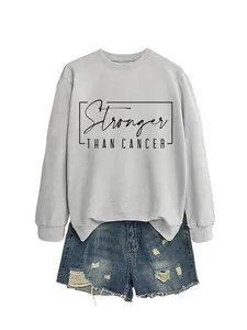 Detail of grey crewneck sweatshirt with Stronger Than Cancer print and denim shorts