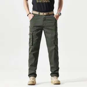 Detail of army green cargo pants featuring large side pockets with snap button closure