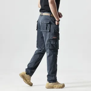 Detail view of cargo pants featuring tactical side pockets and a red fabric label tag