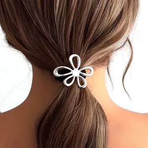 Silver flower hair tie on ponytail featuring a hollow petal design and black elastic band