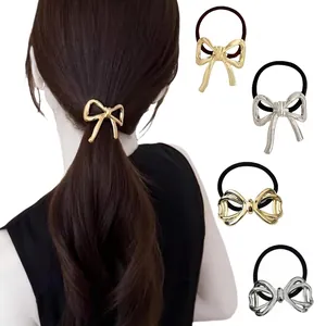 Close-up of gold and silver metallic bow hair ties featuring elegant hollowed designs