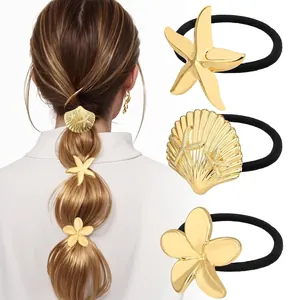 Detail of golden starfish shell and flower charms on elastic hair ties for women