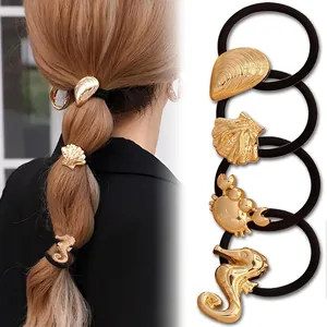 Detailed set of gold marine hair ties featuring shells and crabs on elastic bands