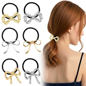 Detail view of gold and silver metallic bow hair ties with high elastic black rubber bands
