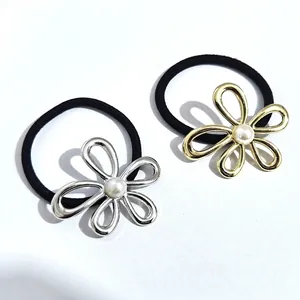 Elegant gold and silver floral metal hair ties with pearl centers on high-stretch bands