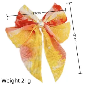 Gradient chiffon bow hair clip with pearl detail, yellow-orange sunset ombre, 17x21cm